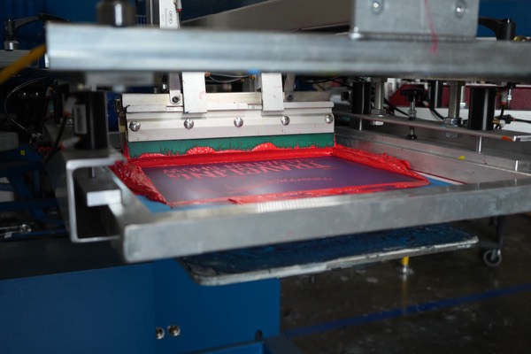 Squeegee pulling ink across a screen at 5Boys